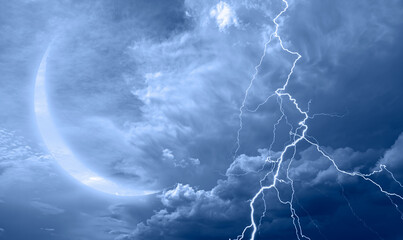 Lightning strikes between blue stormy clouds with crescent moon   © muratart
