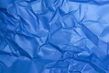 Obraz premium Sheet of crumpled blue paper as background, top view