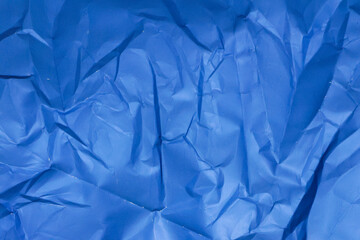 Obraz premium Sheet of crumpled blue paper as background, top view