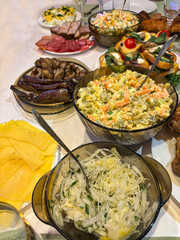 Dishes food on the table festive olivier salad meat sandwiches sprats grilled eggplants.