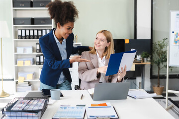 Diverse professionals collaborate on project analysis with financial graphs. Strategic teamwork and insights drive company growth and success.