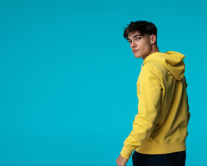 back view of young casual man turning around