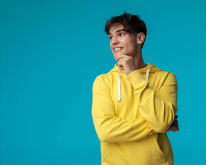 closeup of smiling casual man thinking and looking to side