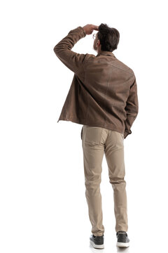 rear view of smart casual man looking up to side