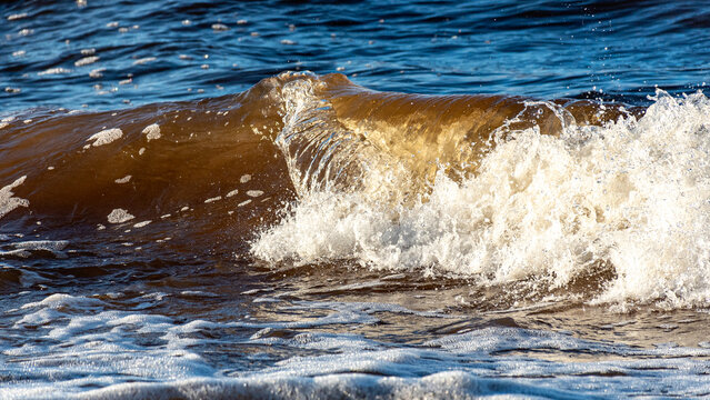 beautiful waves crashing against the seashore, windy day on the rocky shore of Vidzeme, Baltic Sea