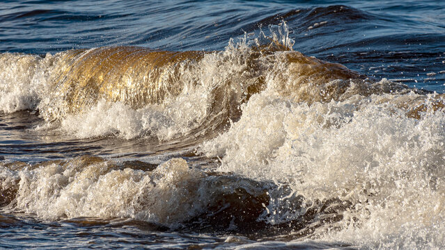 beautiful waves crashing against the seashore, windy day on the rocky shore of Vidzeme, Baltic Sea