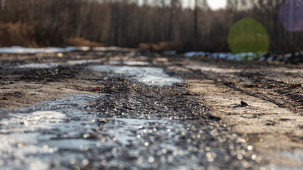 abstract frozen ice texture on muddy swamp road