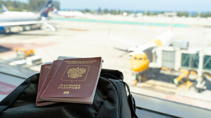 passport in hands or on suitcases at the airport. translation: Russian federation passport