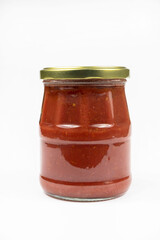  Tomato paste in glass jar isolated on white background.