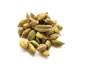 Aromatic pile of cardamom seeds on a white background.