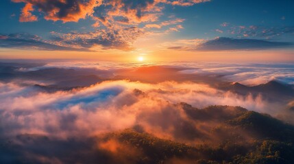 Fototapeta premium Vibrant sunset over misty mountain range.