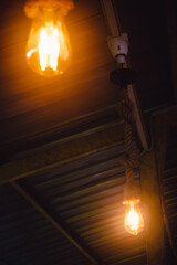 Vintage light bulb in the dark room. Selective focus.