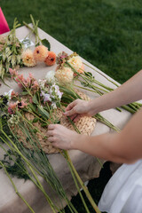 Close-up photo of a florist creating a bouquet of fresh flowers