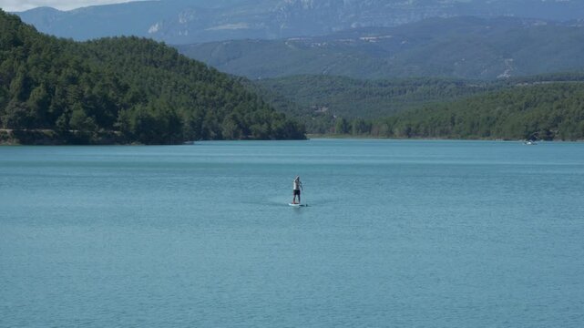 Man or person rowing on a board in Sant Pon&ccedil; lake in Catalonia