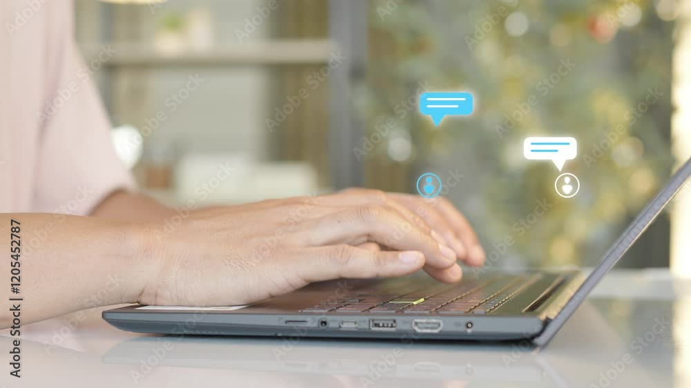 Wall mural close-up of hands typing on a laptop keyboard with digital chat bubble icons hovering above, symboli