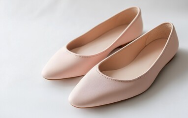 Comfortable slip-on ballet flats in soft blush pink on a bright white backdrop