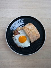 A plate of bacon and egg sandwich.