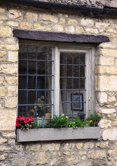 Close up picture of a traditional wooden window of a rural brick cottage in Castle Combe Village, Cotswold