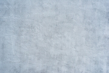 Textured Concrete Wall: A detailed close-up reveals the subtle variations in tone and texture of a light gray concrete wall, offering a minimalist backdrop