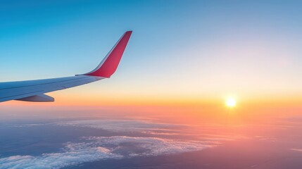 A red and white airplane wing is flying through a beautiful blue sky with a larg