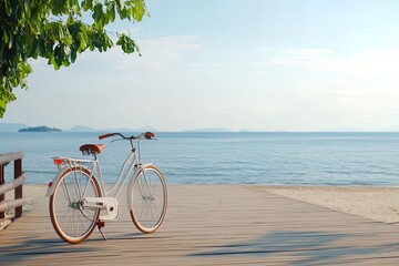 Fototapeta premium Bicycle parked on a wooden deck overlooking a calm beach in bright sunlight by the water