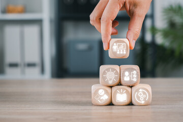 Wooden blocks with icons symbolize capacity building, showcasing growth, development, and skill...
