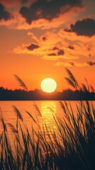 Golden sunset over a tranquil lake with silhouetted grass in the foreground reflecting serene beauty at dusk