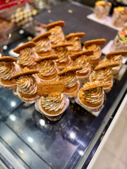 Biscuit cupcake with cream decoration at showcase of bakery