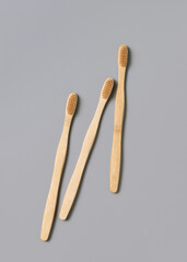 Biodegradable bamboo toothbrushes on a light gray top view. Zero waste and no plastic concept