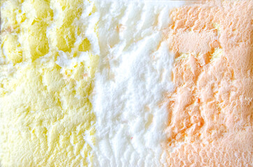 texture of yellow white and green ice cream like background, close up. Strawberry ice cream texture close up. Top view. Pink fruit ice cream background with small pieces of berries. High quality photo