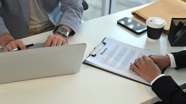 Job applicant answering questions during job interviewing in modern office