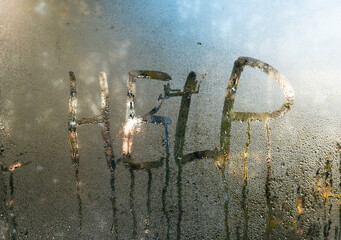 the word help concept. the inscription on the wet glass