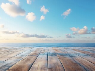 Serene ocean view from a wooden deck under a clear blue sky with scattered clouds.