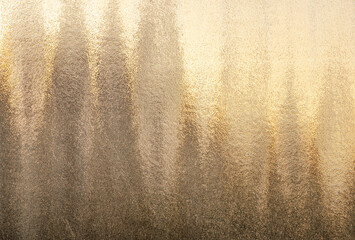 abstract background embossed glass window texture at sunset golden hour close up