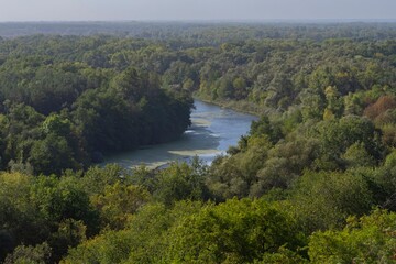 Obraz premium Beautiful view of the river from the top of the hill. Landscape with a river and a steep bank on an autumn morning.