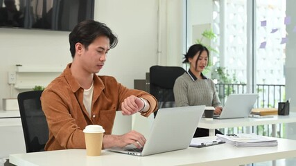 Smiling colleagues leaving their modern office setting for a lunch break - Powered by Adobe