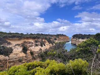 Loch Ard Gorge, situated along the Great Ocean Road in Victoria, is a stunning natural wonder featuring dramatic limestone cliffs, clear blue waters, and a historical shipwreck site, with walking trai