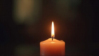 Serene candle in dark space symbol of hope and remembrance for cancer.