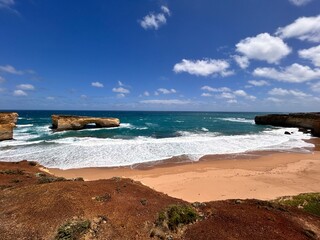 London Bridge, along the Great Ocean Road, is a natural rock formation that once resembled a bridge. It collapsed in 1990, leaving two rock pillars, creating a unique coastal landmark.