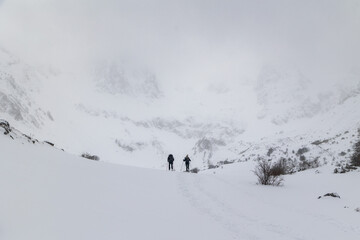 Snowshoe Hikers Exploring Snowy Mountains in Parque Montaña de Riaño, Leon, Spain