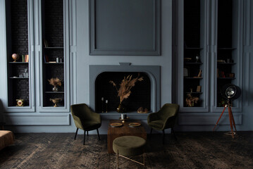 Classic room interior featuring green armchairs, wooden table, and decorative fireplace.