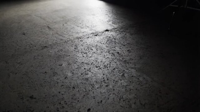 Abstract image of Studio dark room concrete floor texture background with lighting effect.