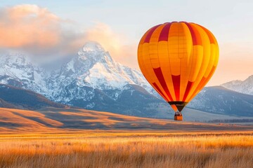 Obraz premium A hot air balloon floating over the Jackson Hole Valley, with the Tetons providing a stunning backdrop