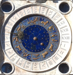 Sundial with zodiacal signs and a golden sun at St. Marks square in Venice
