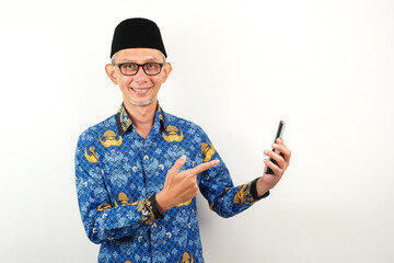 Handsome government worker man wearing korpri batik holding smartphone while smiling. ASN civil...