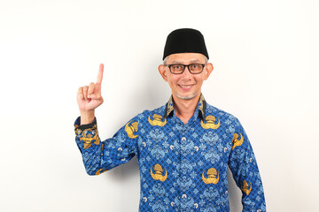Happy government worker man wearing korpri batik pointing to the copy space. ASN civil servant 
