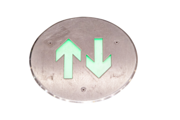 Neon green arrow directions electric glowing on aluminum circle plate isolated on cut out PNG or transparent background. At airport with light and shadow from light. Symbol Inform tourist about place.