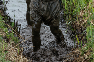 Mud-filled marsh in Nederland tests endurance as participants wade through thick sludge during an adventurous race event