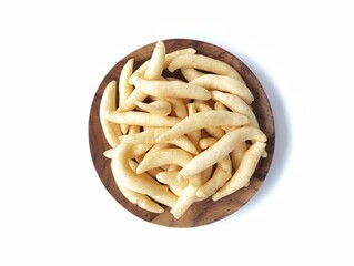 Kue telur gabus or Indonesian traditional cake on plate isolated on white background, top view angle 