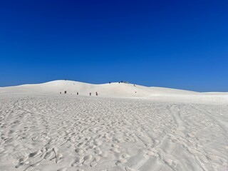 Lancelin, a coastal town in Western Australia, is famous for its white sand dunes, perfect for sandboarding, off-road adventures, pristine beaches, windsurfing, and a relaxed atmosphere.